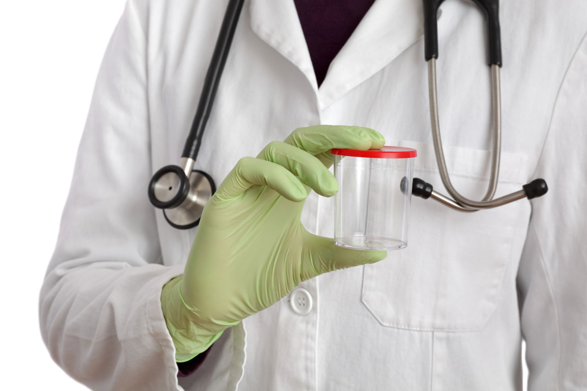 Person in lab coat holding an empty cup with a red lid.