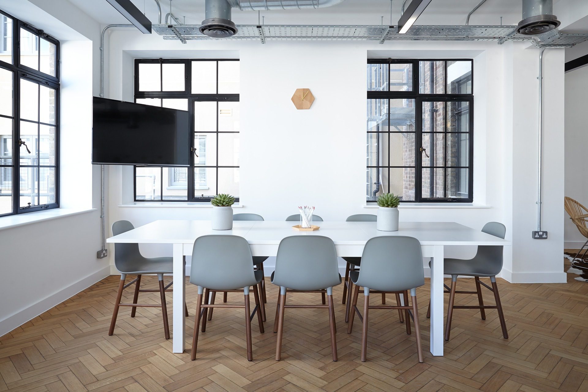 White walled office with a meeting table.