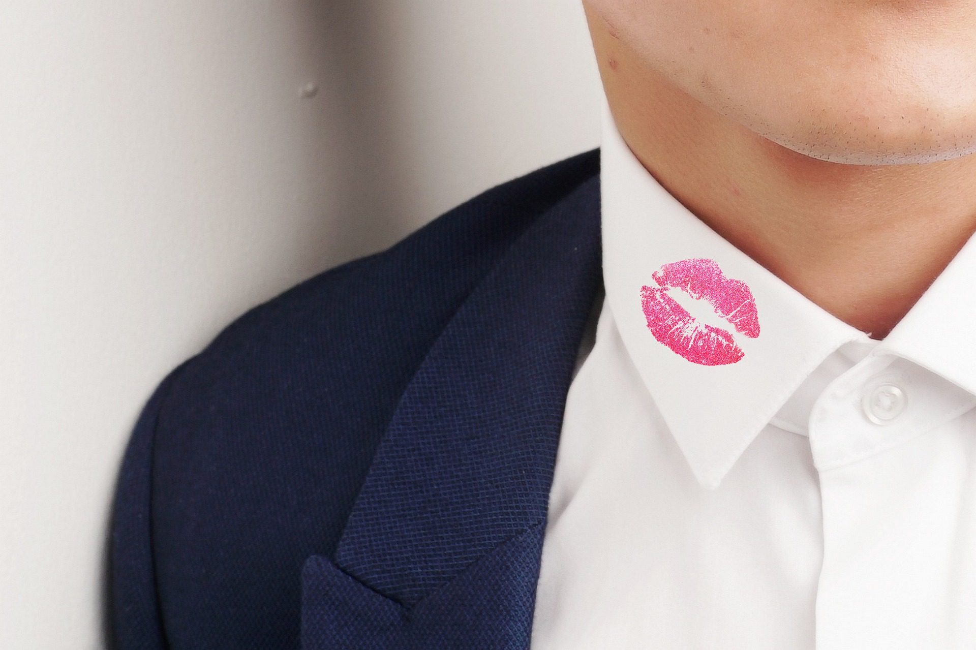 Man with a lipstick mark on his collar.